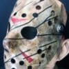 Side angle of the Freddy vs Jason mask showing detailed claw-like markings, bold red accents, and black elastic strap.