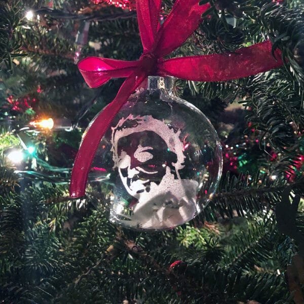 Glass ornament featuring Michael Myers, adding a spooky holiday touch.