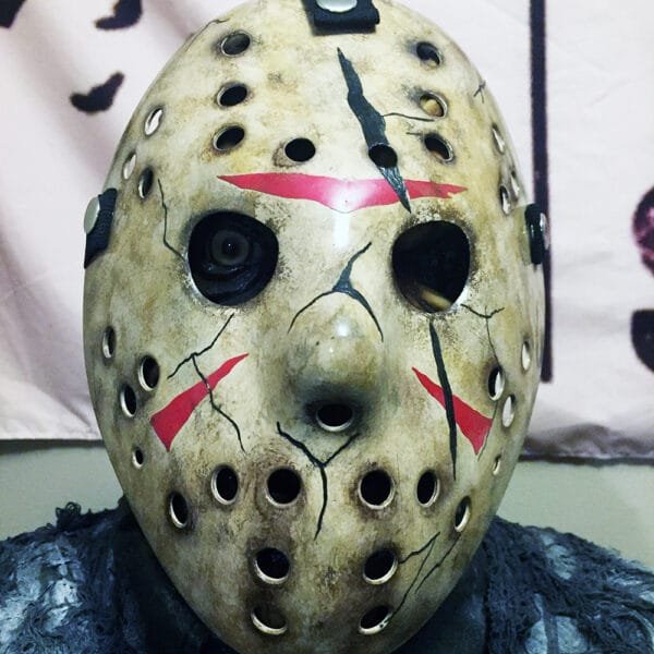 Front view of the Mortal Kombat X Jason Mask featuring a weathered finish, black cracks, and red chevrons.