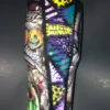 A Nightmare Before Christmas Sally tumbler with colorful text, glowing pumpkins, and Sally-inspired patchwork stripe.