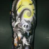 The back of the tumbler displays Jack Skellington under a glowing full moon with swirling ghostly accents.