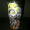 Front view of the Nightmare Before Christmas tumbler with Jack Skellington, a glowing moon, and pumpkins.