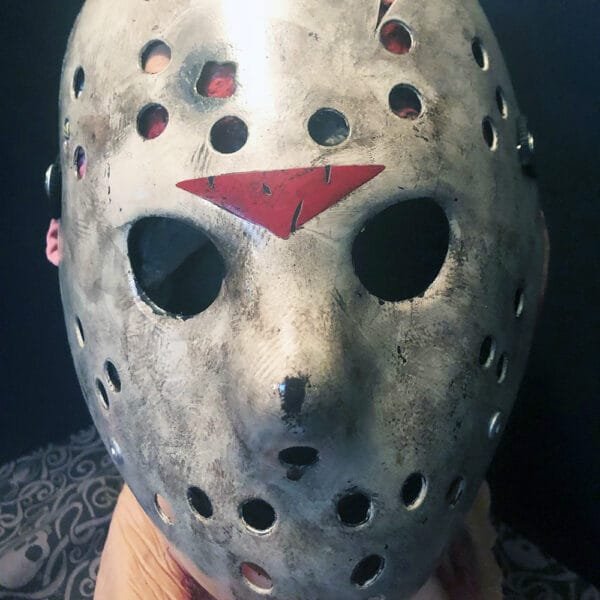 Front view of the Friday the 13th Part 6 Mask Version 1 with subtle weathering, red chevron, and bullet hole.