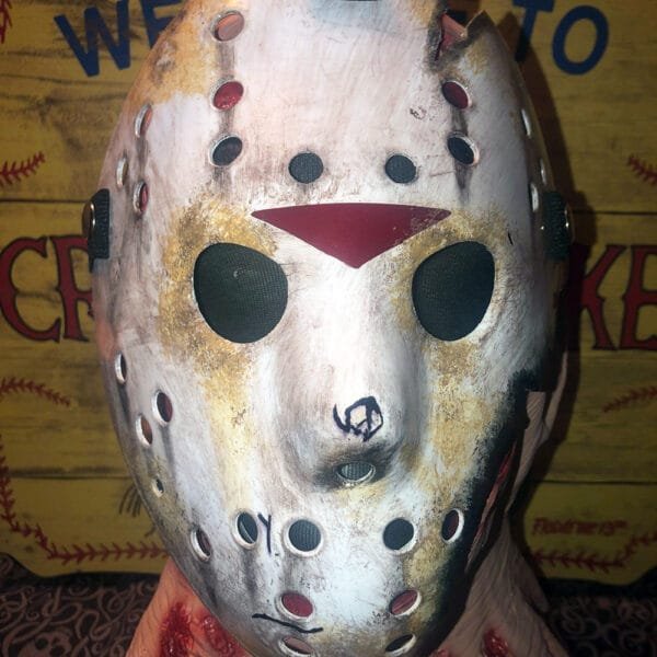 Front view of the Friday the 13th Part 7 mask featuring battle damage and weathered details.