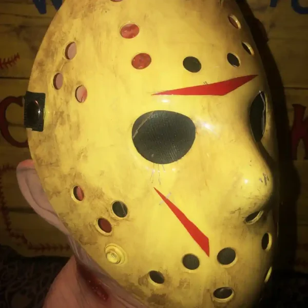 Angled view of the mask with visible removable straps and gritty detail.