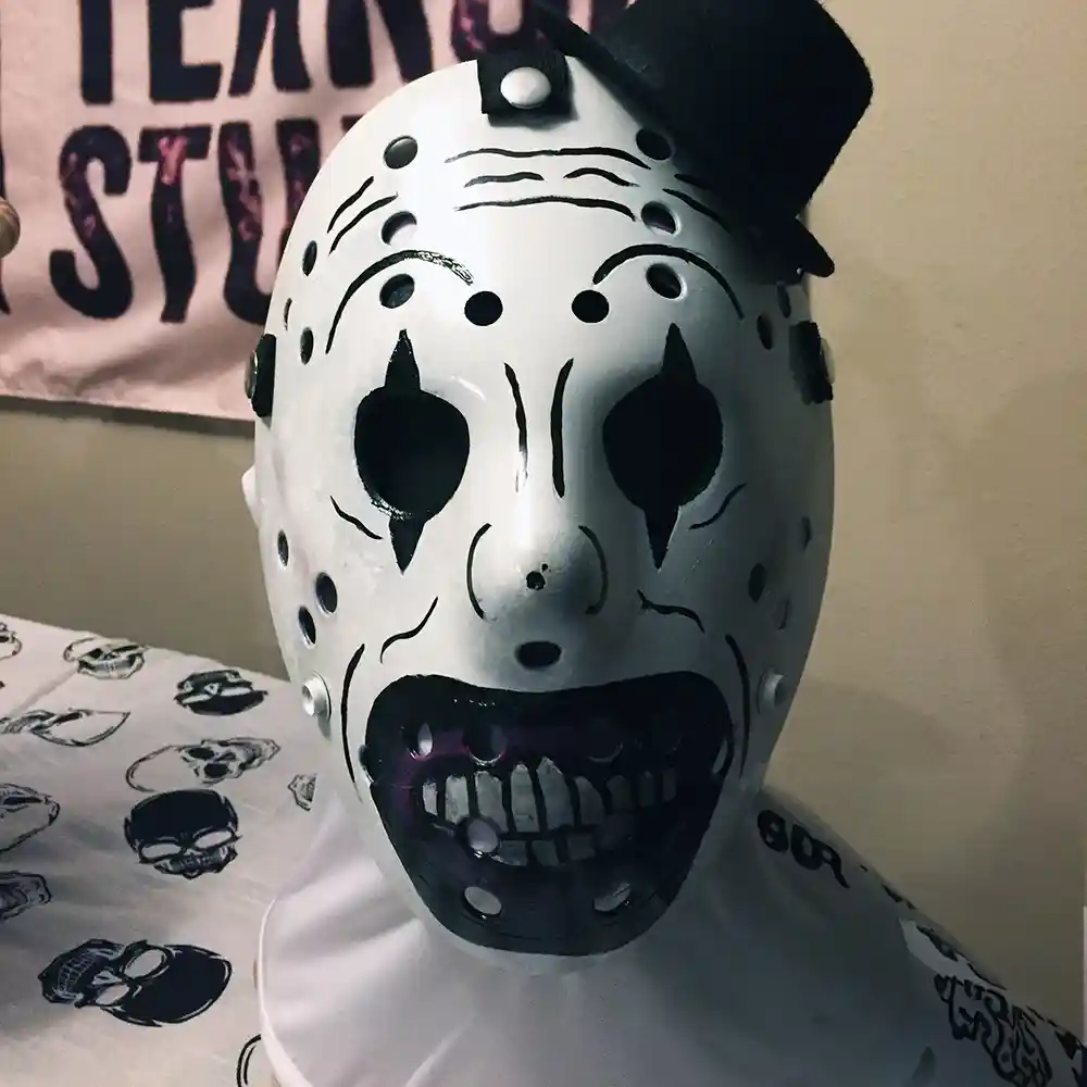 Terrifier mask featuring Art the Clown's sinister black-and-white design with hand-painted details and a mini top hat